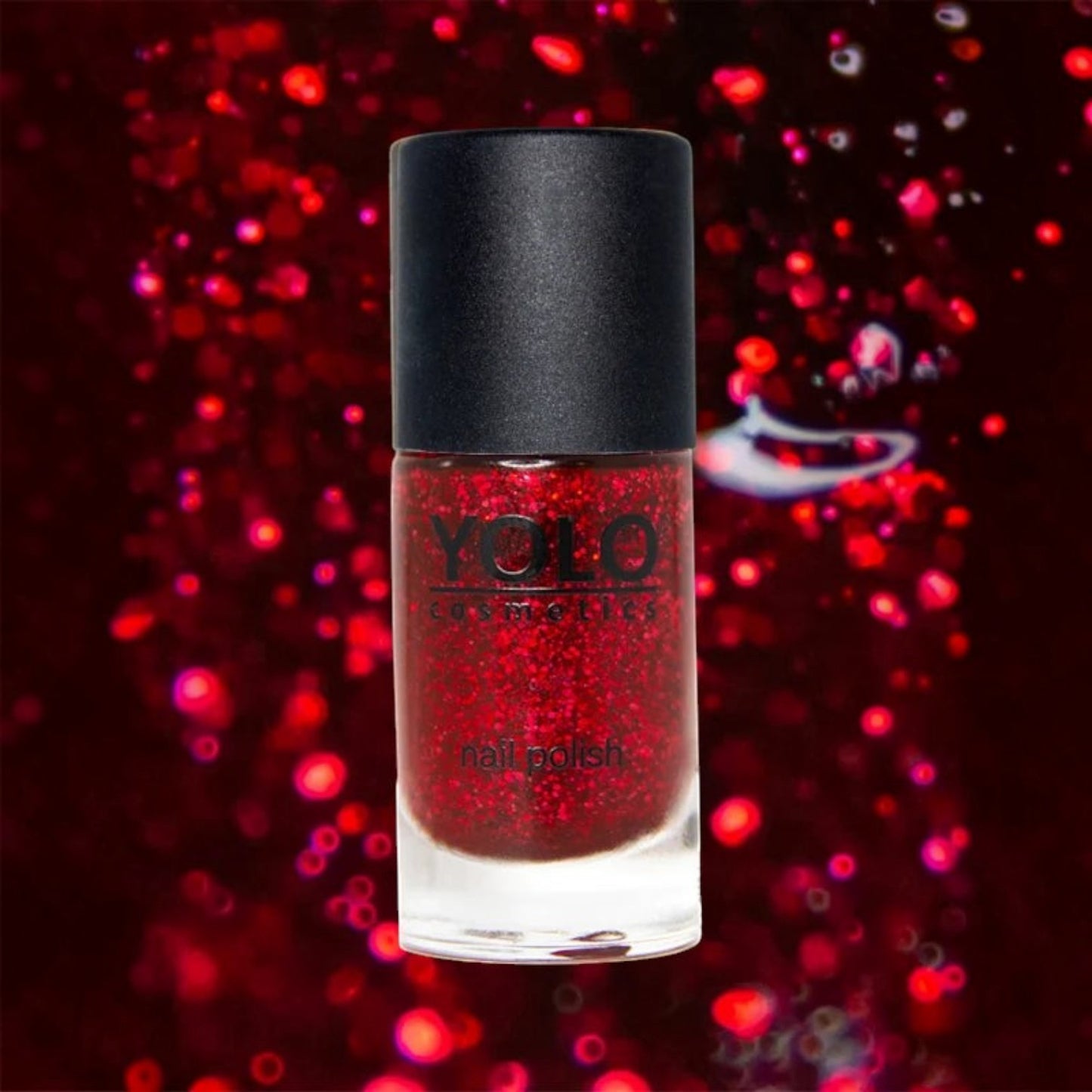 Said Salem YOLO Red glitter nail polish in a sleek glass bottle with a black cap against a sparkling red background
