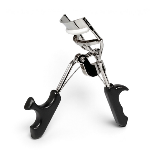 Said Salem Fe Lash Curler featuring a stainless steel frame, ergonomic black grips, and a soft white silicone pad.