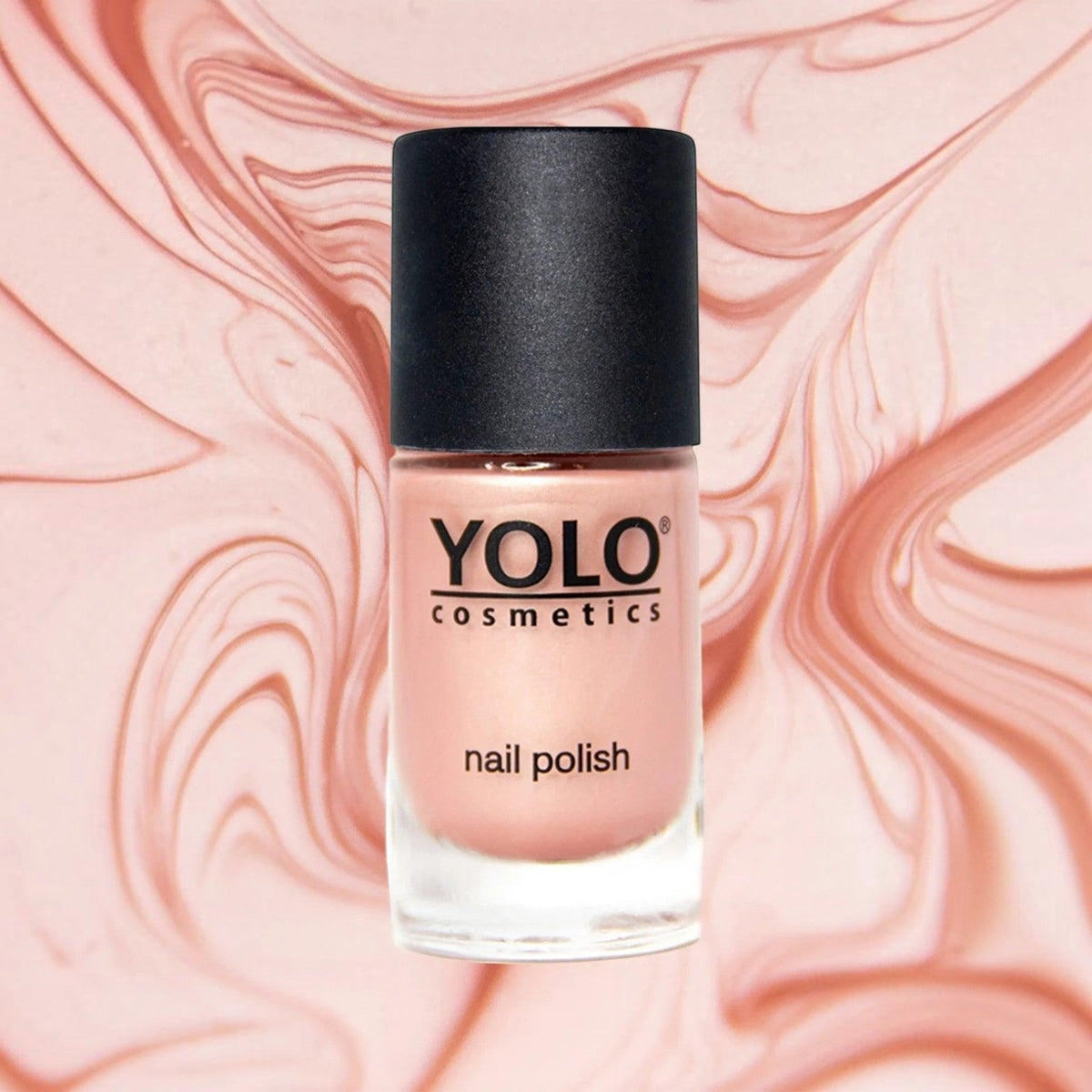 Said Salem YOLO Beige nail polish in a glass bottle with a black cap against a swirling pink marble background.