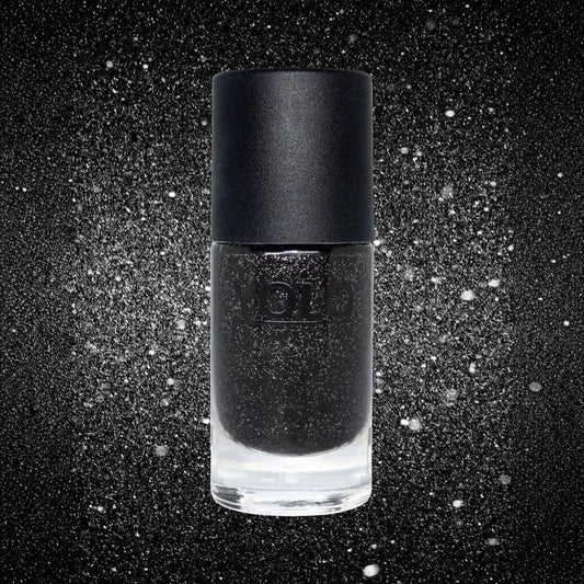 Said Salem YOLO BLACK nail polish in a glass bottle with a matte black cap against a sparkling dark background.