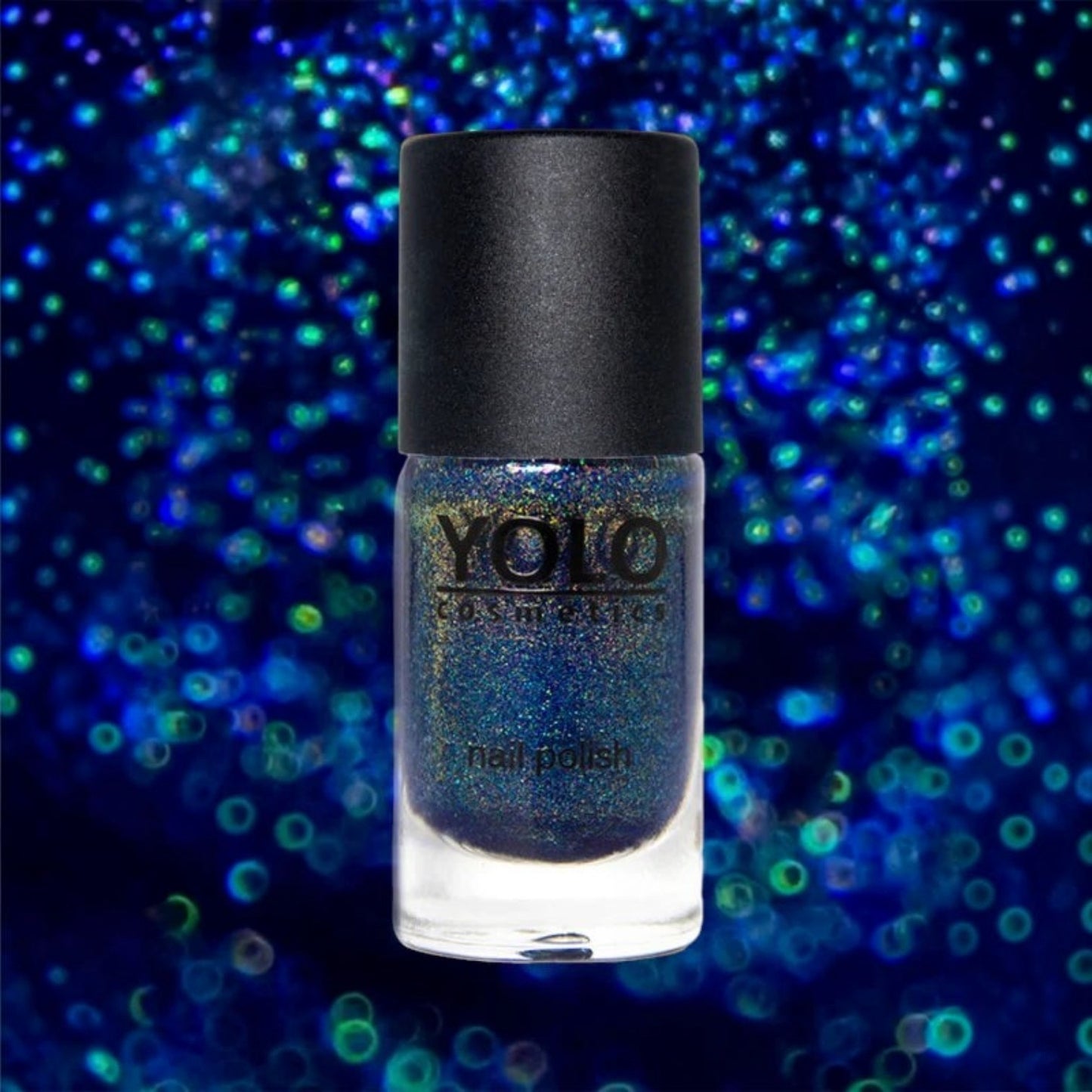 Said Salem YOLO Blue holographic nail polish bottle with a high-shine finish against a sparkling blue bokeh background.