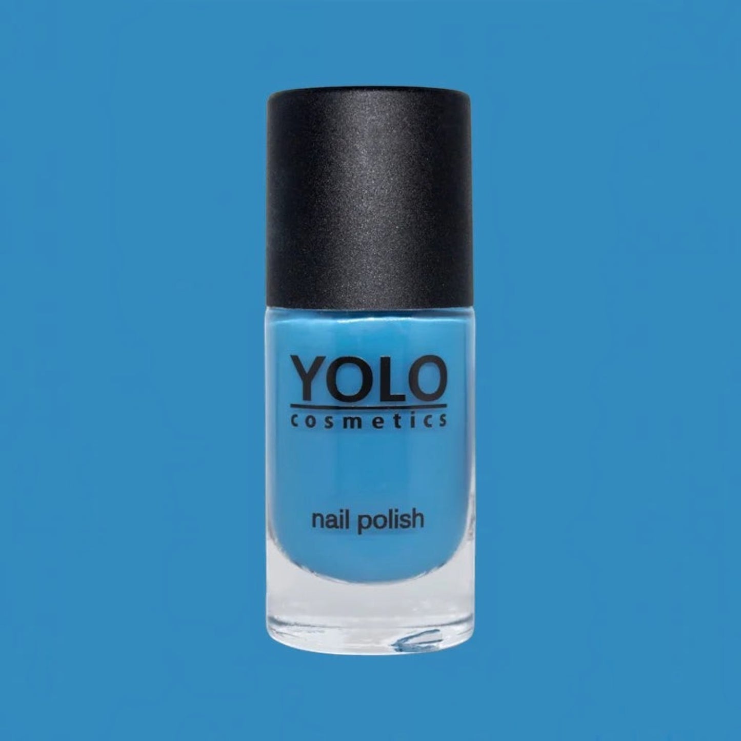 Said Salem YOLO Blue high-pigment sky blue nail polish in a glass bottle with a black cap against a blue background.