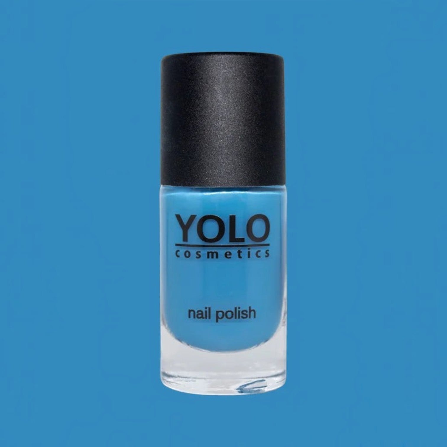 Said Salem YOLO Blue high-pigment sky blue nail polish in a glass bottle with a black cap against a blue background.