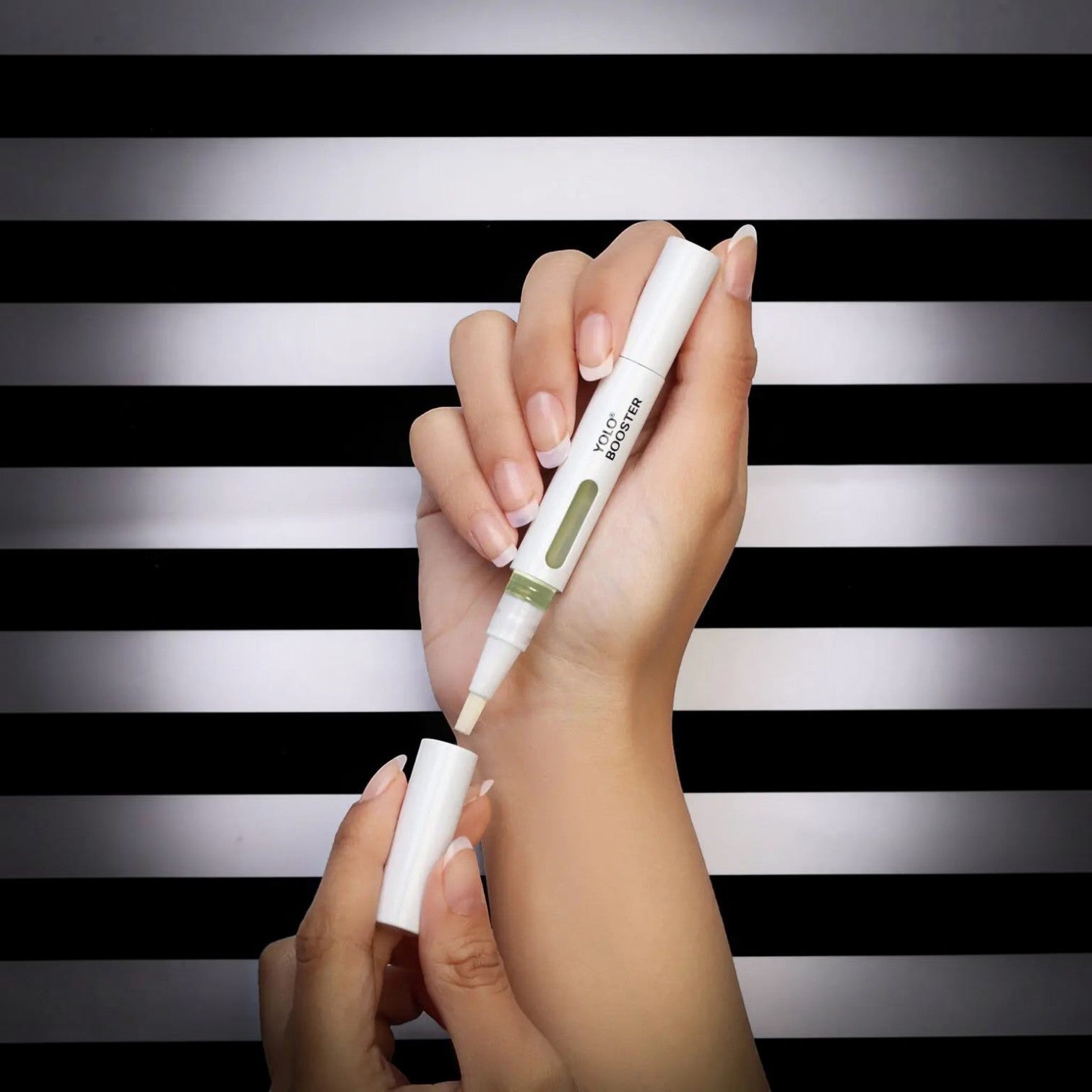 Said Salem YOLO Booster Serum Pen held in a hand, featuring a white applicator brush for nourishing nail care.