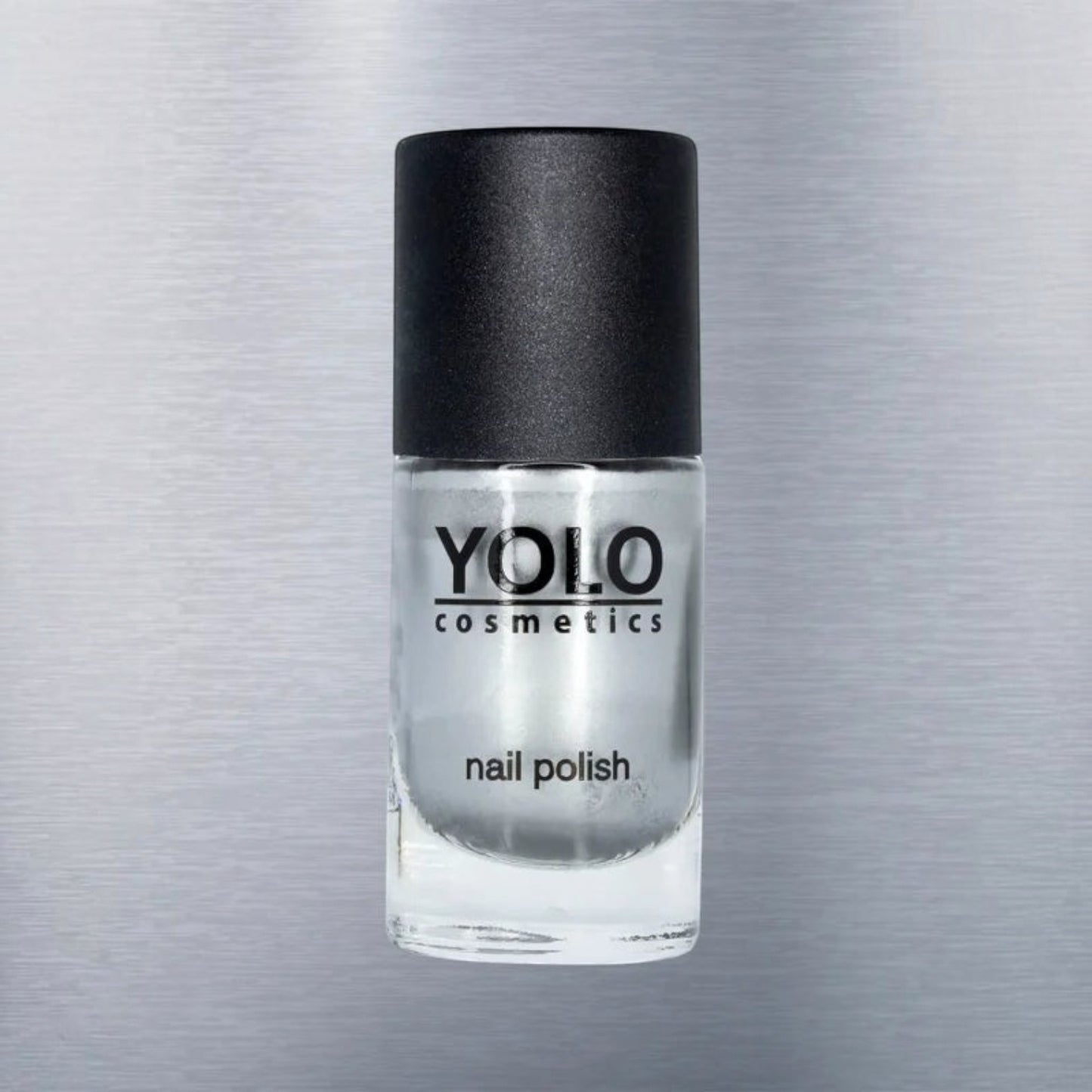 Said Salem YOLO Gray metallic silver nail polish in a clear glass bottle with a black cap against a brushed metal background.