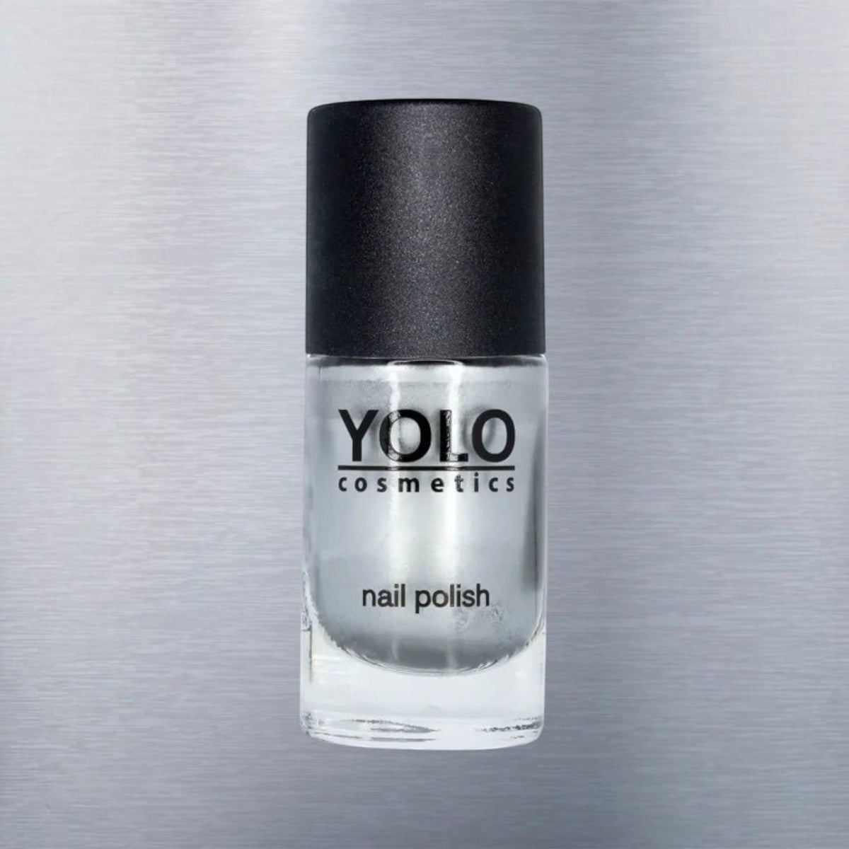 Said Salem YOLO Gray metallic silver nail polish in a clear glass bottle with a black cap against a brushed metal background.