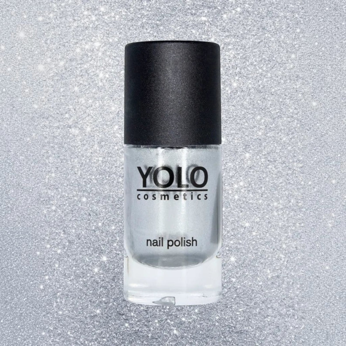 Said Salem YOLO Gray metallic silver nail polish in a glass bottle with a black cap against a glittery background.