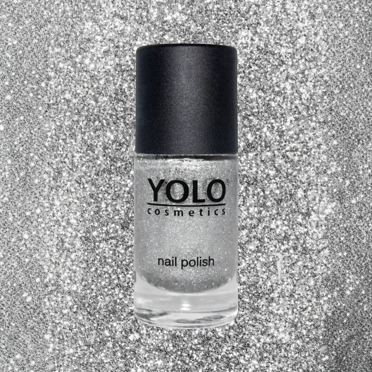 Said Salem YOLO Gray shimmering silver glitter nail polish bottle with a black cap against a sparkling background.