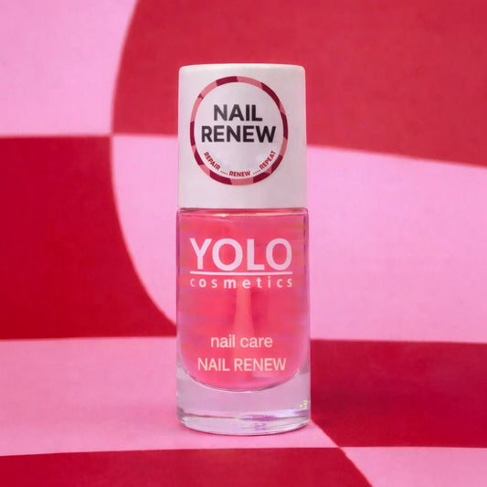 Said Salem YOLO Nail Renew strengthening serum in a clear glass bottle with a pink liquid against a checkered background