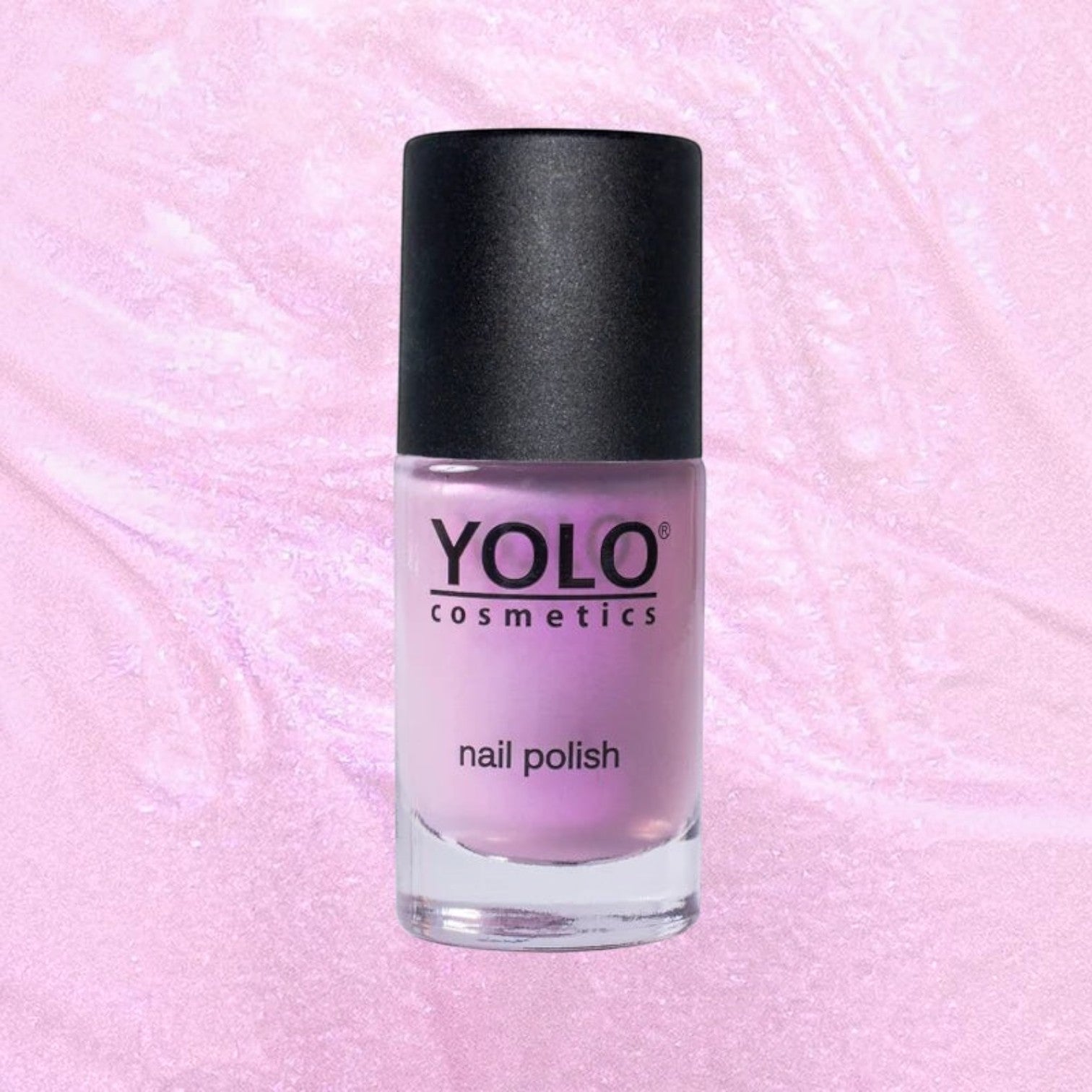 Said Salem YOLO Pink nail polish bottle with a soft pastel pink shade and a black cap against a shimmering background