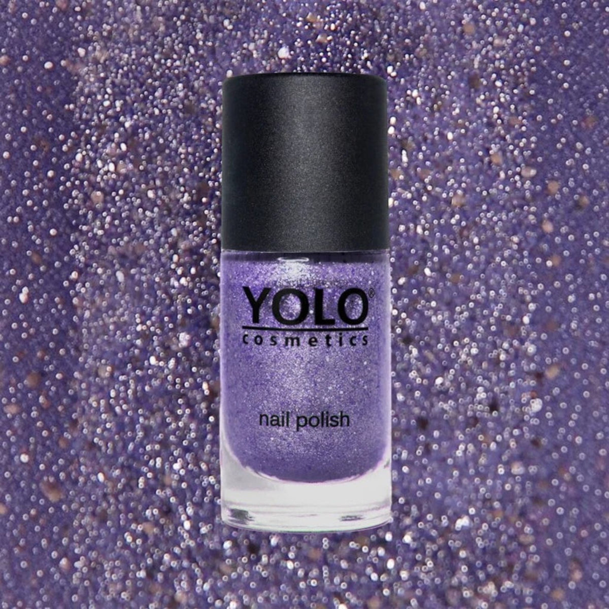 Said Salem YOLO Purple glitter nail polish in a glass bottle with a black cap against a sparkling purple background.