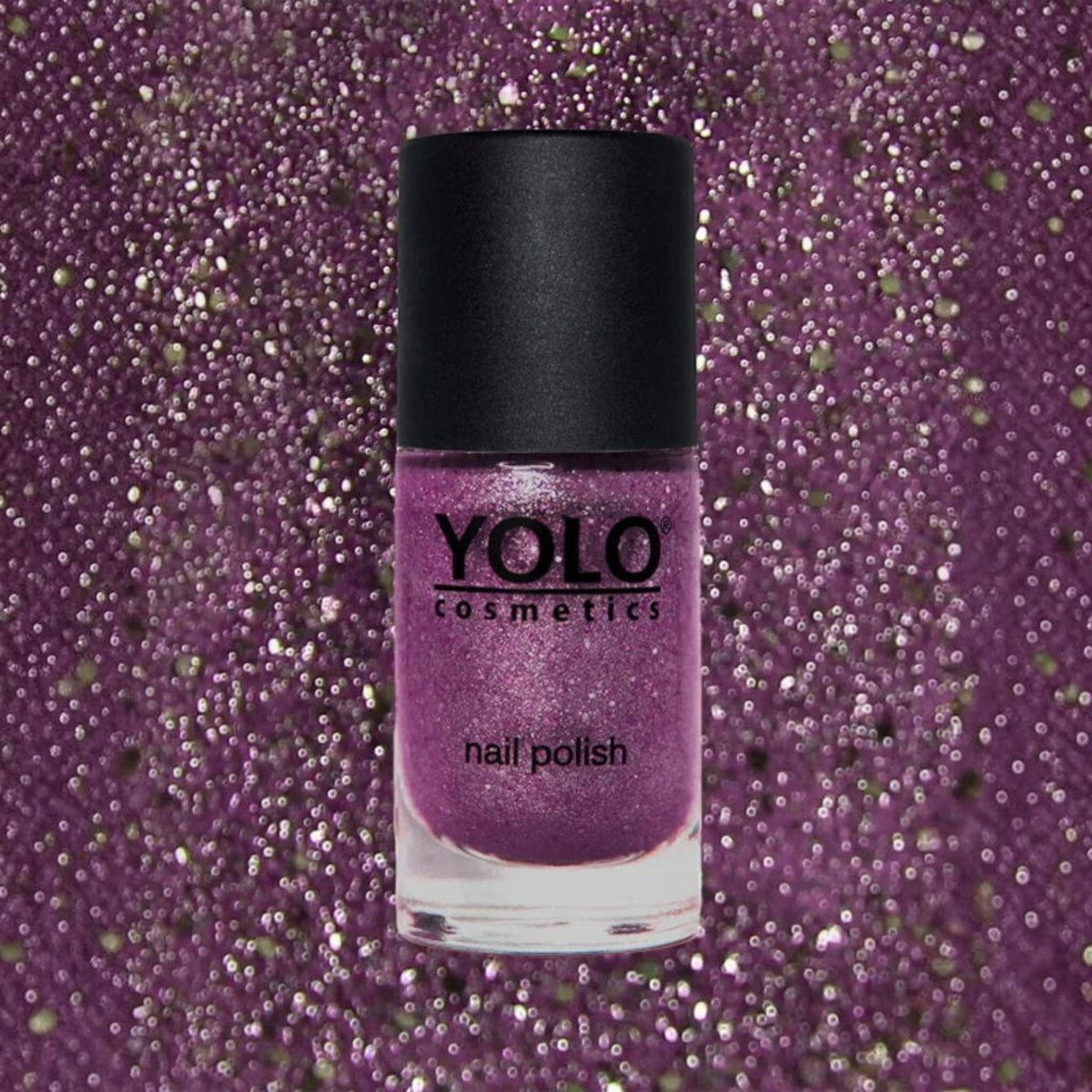 Said Salem YOLO Purple glitter nail polish bottle against a matching sparkling purple background.