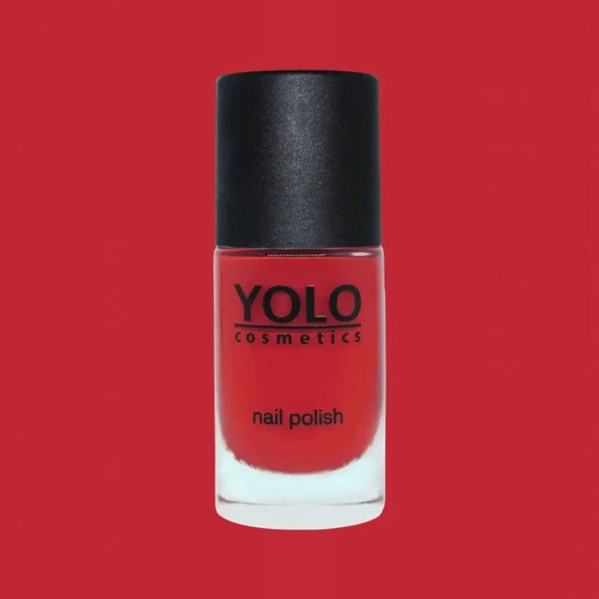 Said Salem YOLO Red nail polish in a sleek glass bottle with a black cap against a vibrant red background.