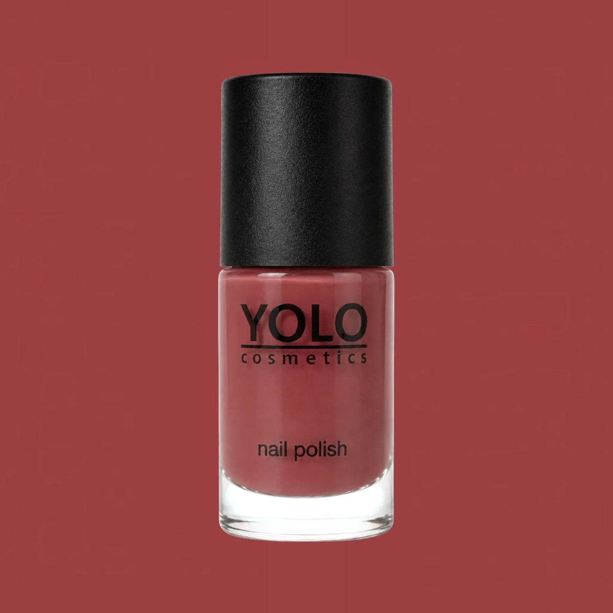 Said Salem YOLO Red nail polish in a sleek glass bottle with a black cap against a matching red background.