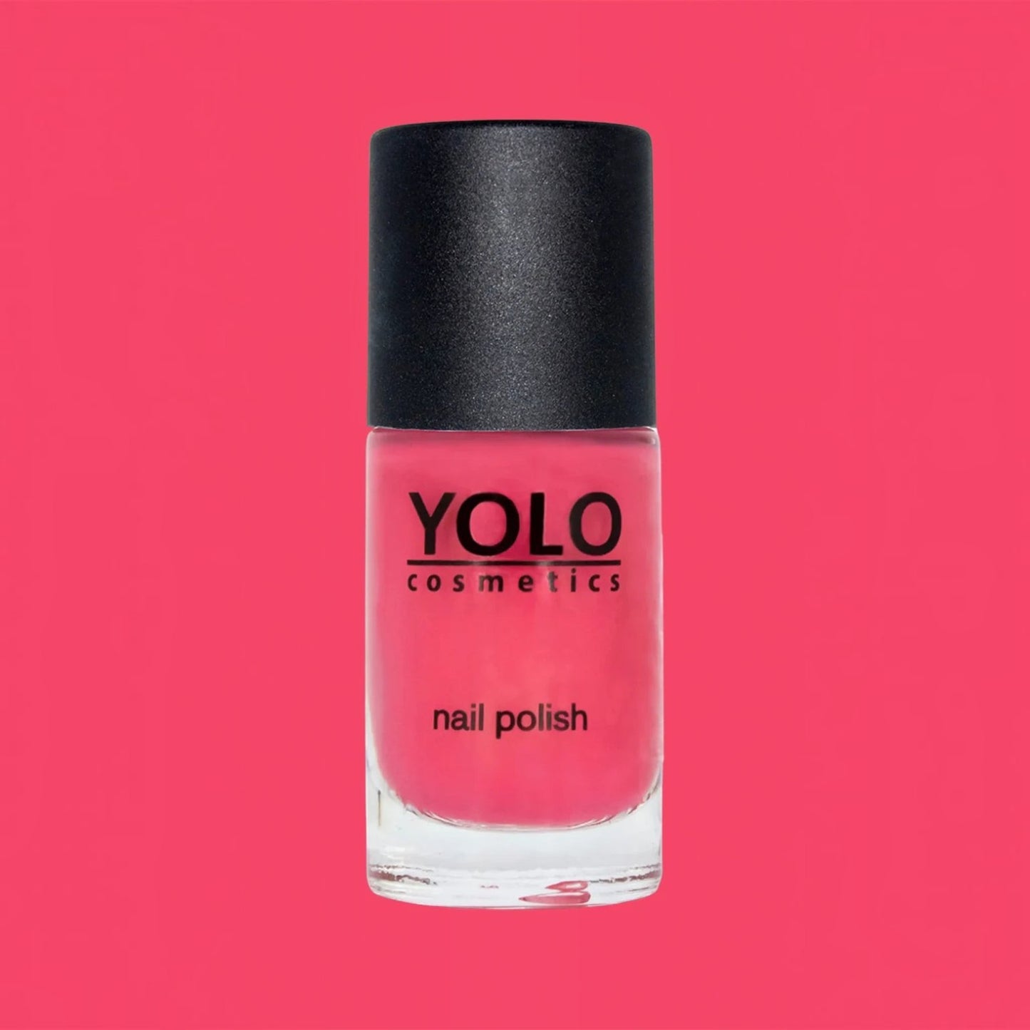 Said Salem YOLO Red nail polish in a clear glass bottle with a black cap against a vibrant red background.