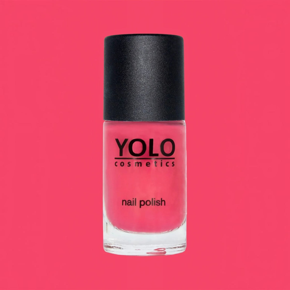 Said Salem YOLO Red nail polish in a clear glass bottle with a black cap against a vibrant red background.