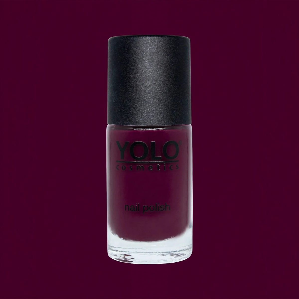 Said Salem YOLO Red nail polish in a sleek glass bottle with a matte black cap, featuring a deep, vibrant red shade.